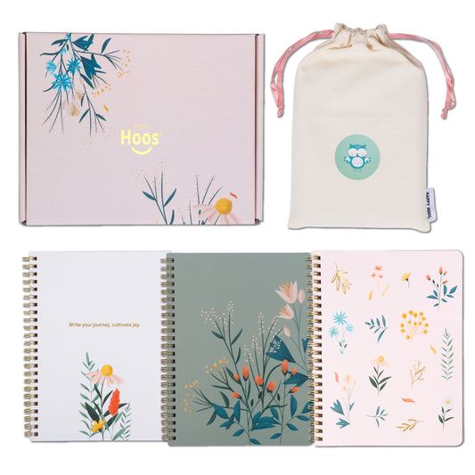 Set of floral notebooks with a drawstring bag and box on a white background