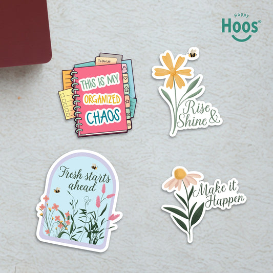 Four Teacher stickers on surface: planner with tabs and "This is my Organized Chaos", yellow daisy with bee and "Rise & Shine", garden dome with "Fresh starts ahead", daisy with "Make it Happen"