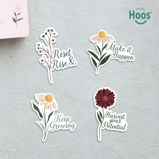 Four Goal Getter stickers on surface: blue berry branches with "Reset & Rise", daisy with "Make it Happen", white daisy with "Keep Growing", burgundy flower with "Harvest your Potential"