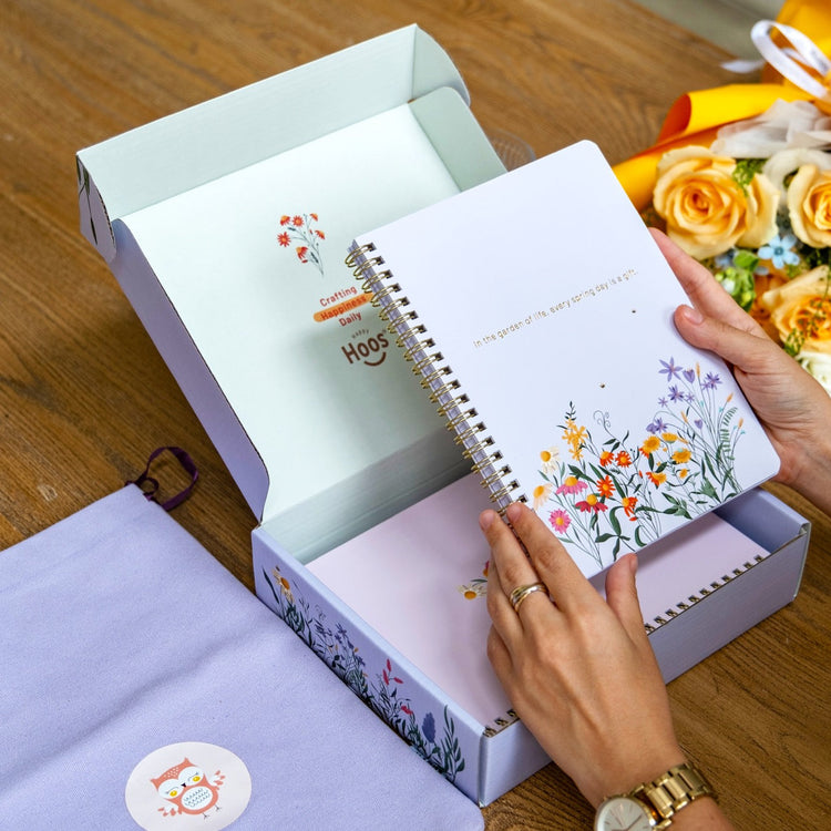 spring spiral notebook, lavender background with spring flowers and words "in the garden of life, every spring day is a gift." 