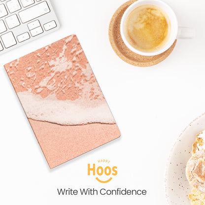 Notebook with pink marble design on a desk with a cup of coffee and food.