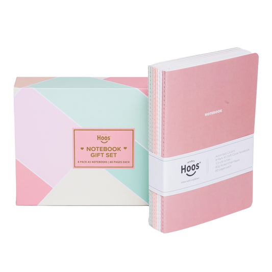 Set of 8 pastel notebooks with white band and geometric-patterned box on a white background