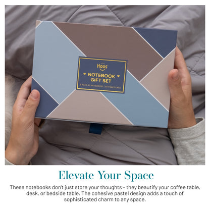 Person holding a winter-themed geometric notebook gift set with 'Happy Hoos' branding.