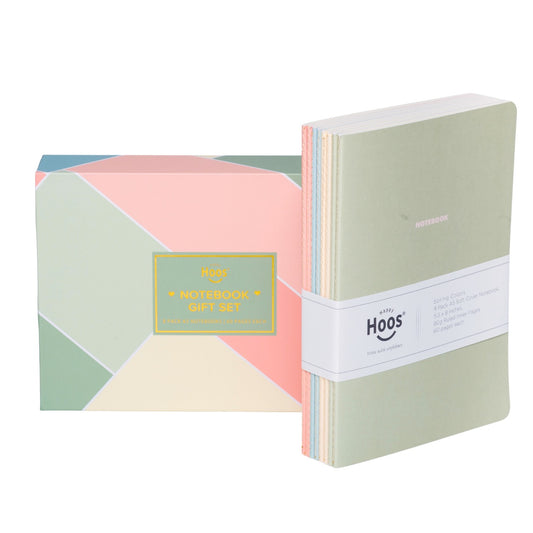 Set of spring notebooks with geometric design packaging on a white background