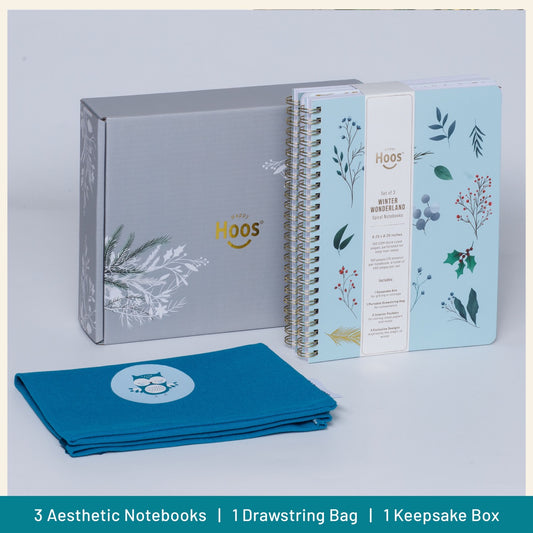 Set of three notebooks with a drawstring bag and keepsake box on a light gray background