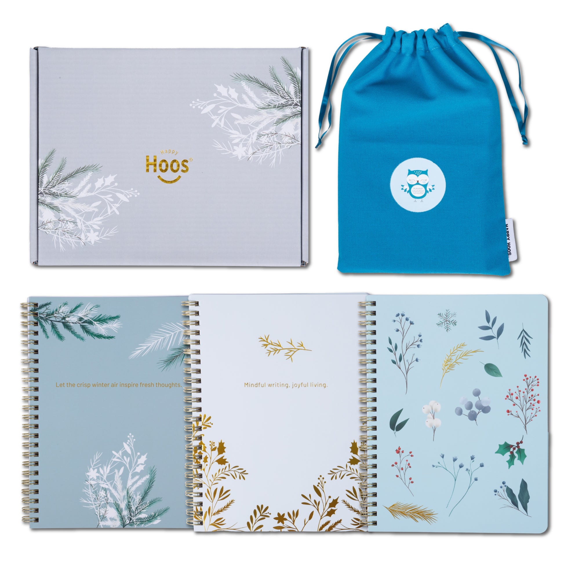 Three notebooks with winter themed floral designs, a box, and a blue drawstring bag on a white background