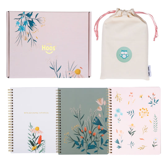 Set of floral notebooks with a drawstring bag and box on a white background
