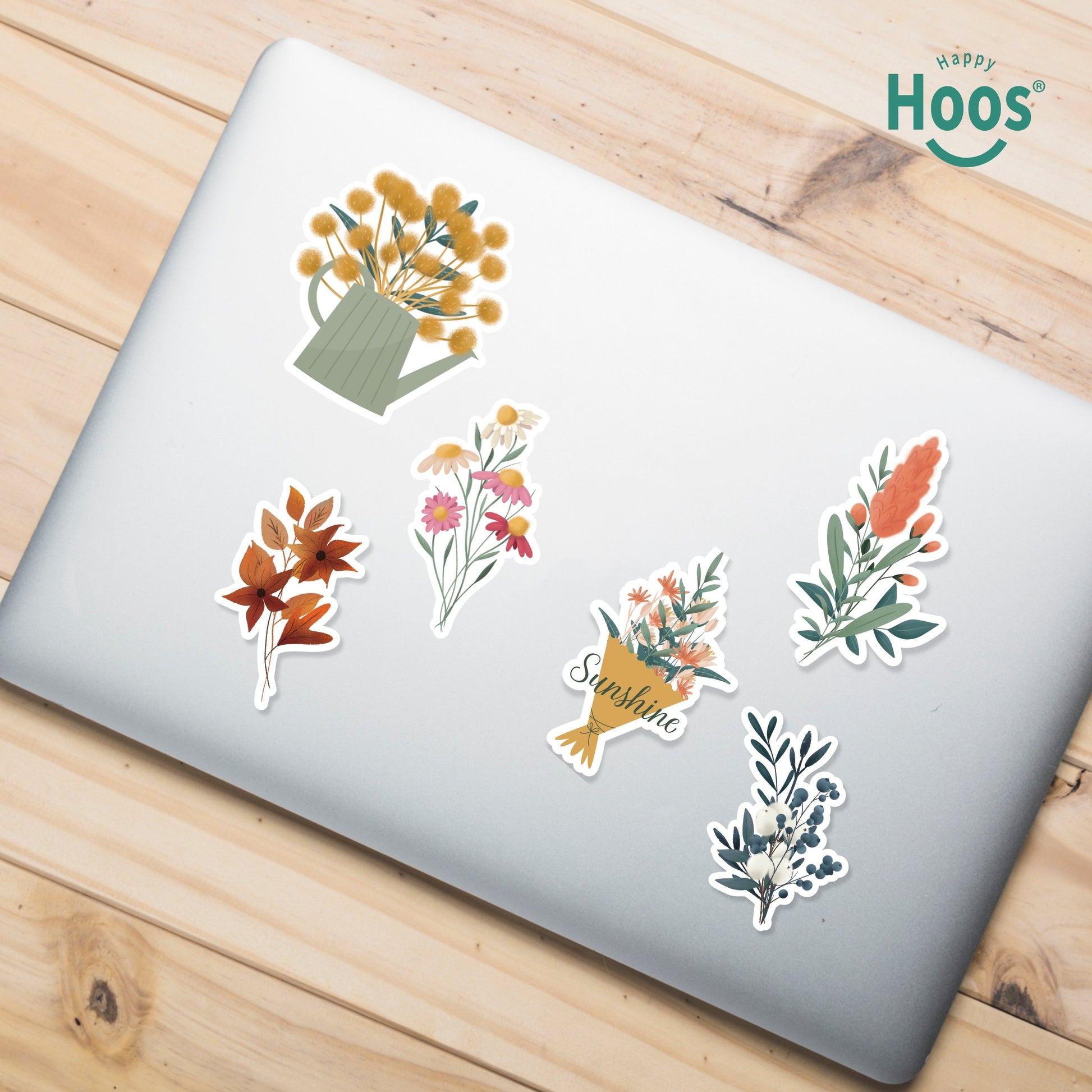 Laptop decorated with Botanical Florals stickers: yellow flowers in watering can, orange autumn leaves, colorful wildflower bouquet, flower bouquet with "Sunshine", coral botanical stem, winter botanical with berries