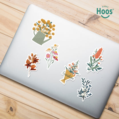 Laptop decorated with Botanical Florals stickers: yellow flowers in watering can, orange autumn leaves, colorful wildflower bouquet, flower bouquet with "Sunshine", coral botanical stem, winter botanical with berries