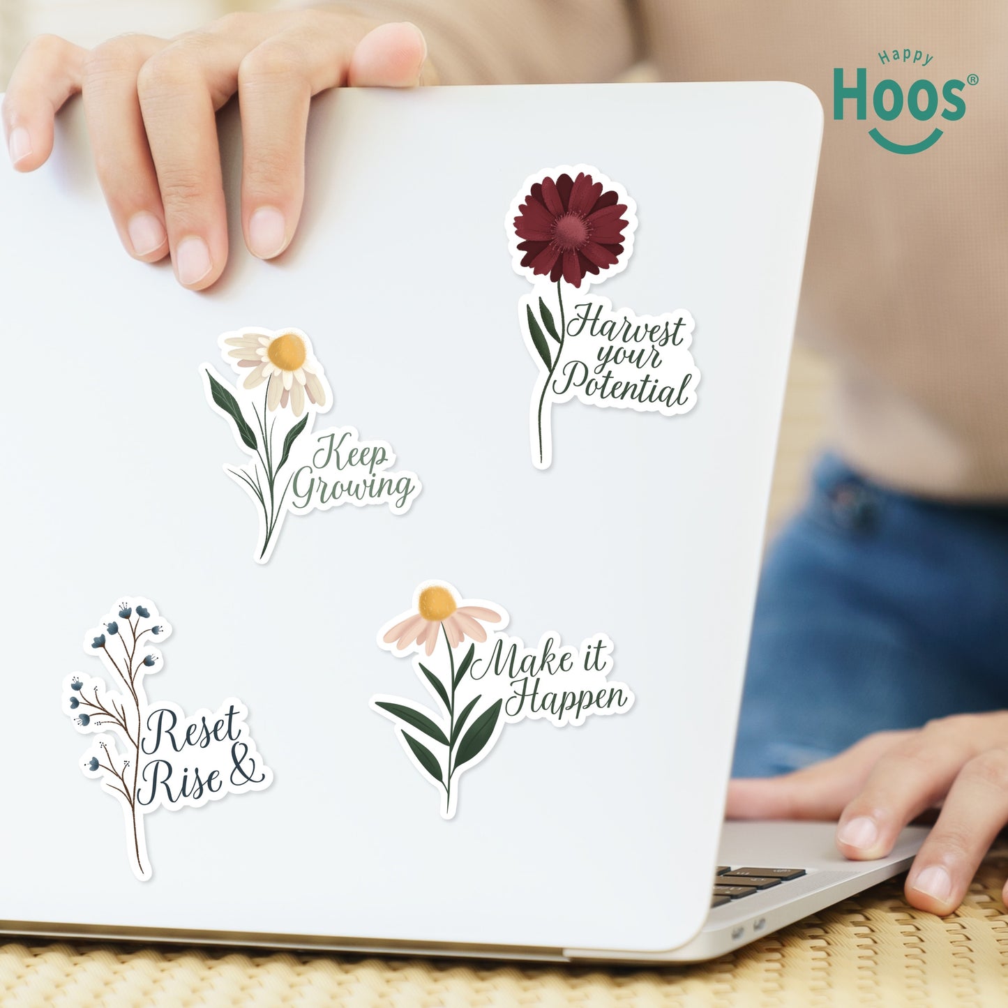 Four motivational flower stickers on white laptop: 'Make it Happen', 'Reset Rise &', 'Harvest your Potential', and 'Keep Growing' designs for healthcare workers