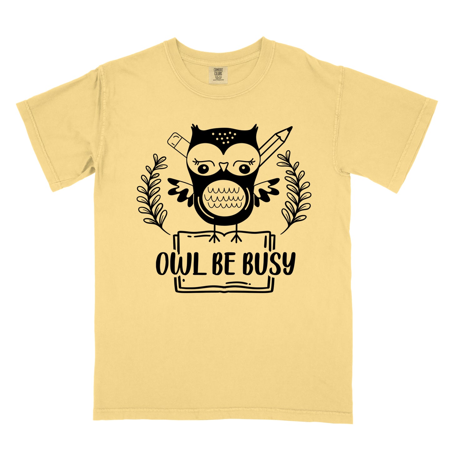 Butter colored  t-shirt with an owl graphic and 'OWL BE BUSY' text.
