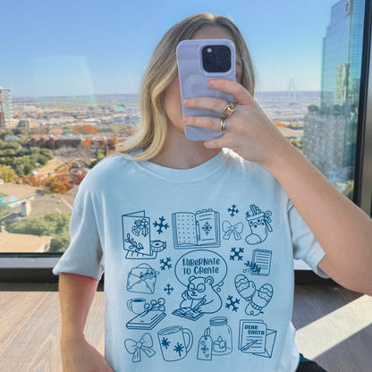 Person wearing vintage Heavyweight Light Blue 100% Cotton with Winter Doodles design