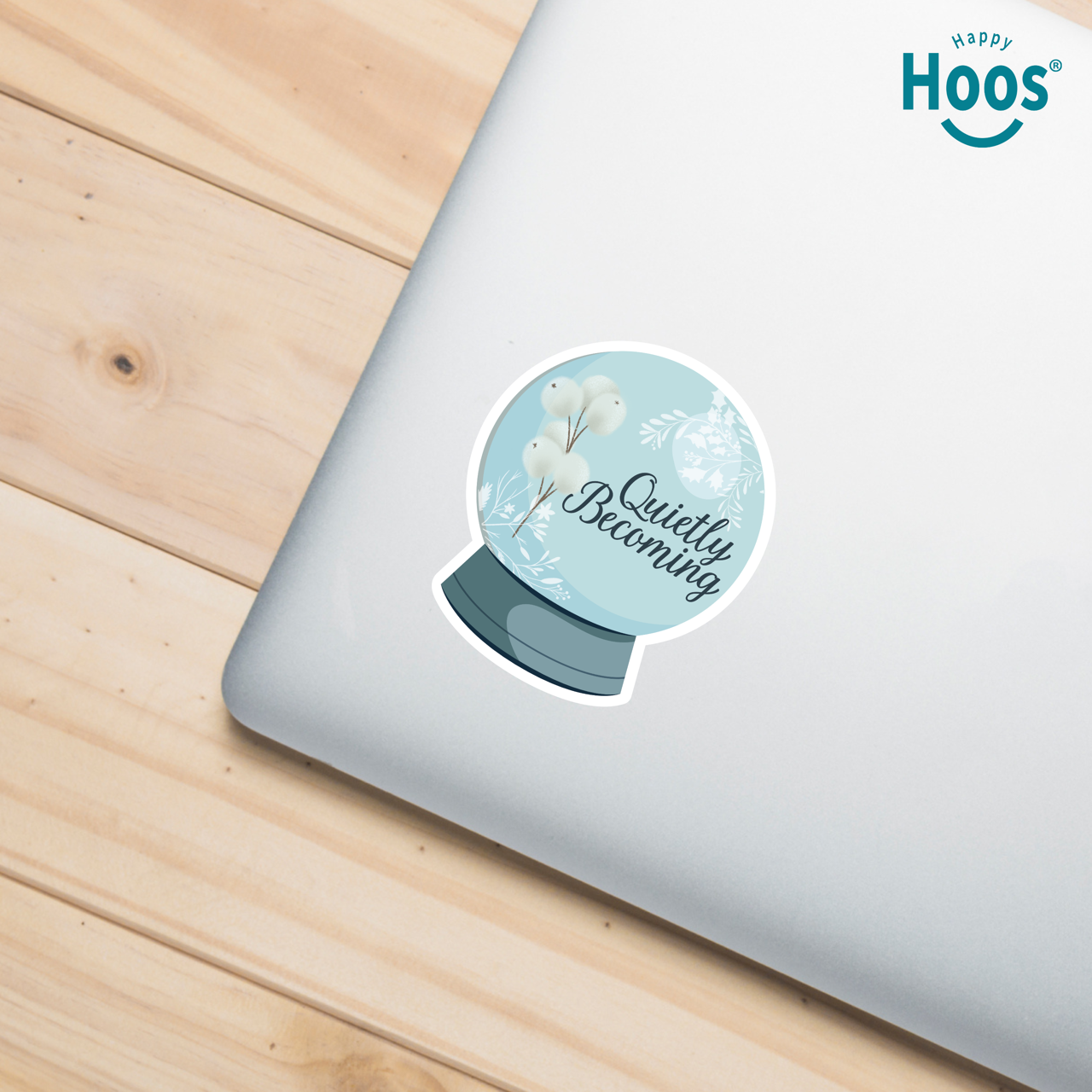 Sticker with 'Quietly Blooming' text on a laptop with 'Happy Hoos' branding.