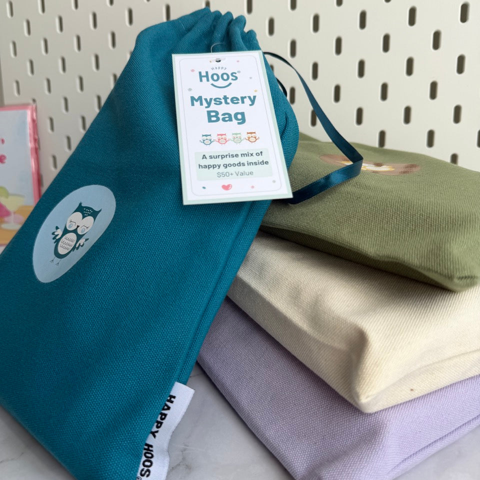 Stack of fabric bags with a 'Mystery Bag' label on a marble surface.