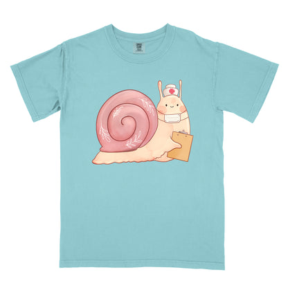 Chalky mint t-shirt with an illustration of  snail holding a clipboard and wearing a nurse's hat and face mask.