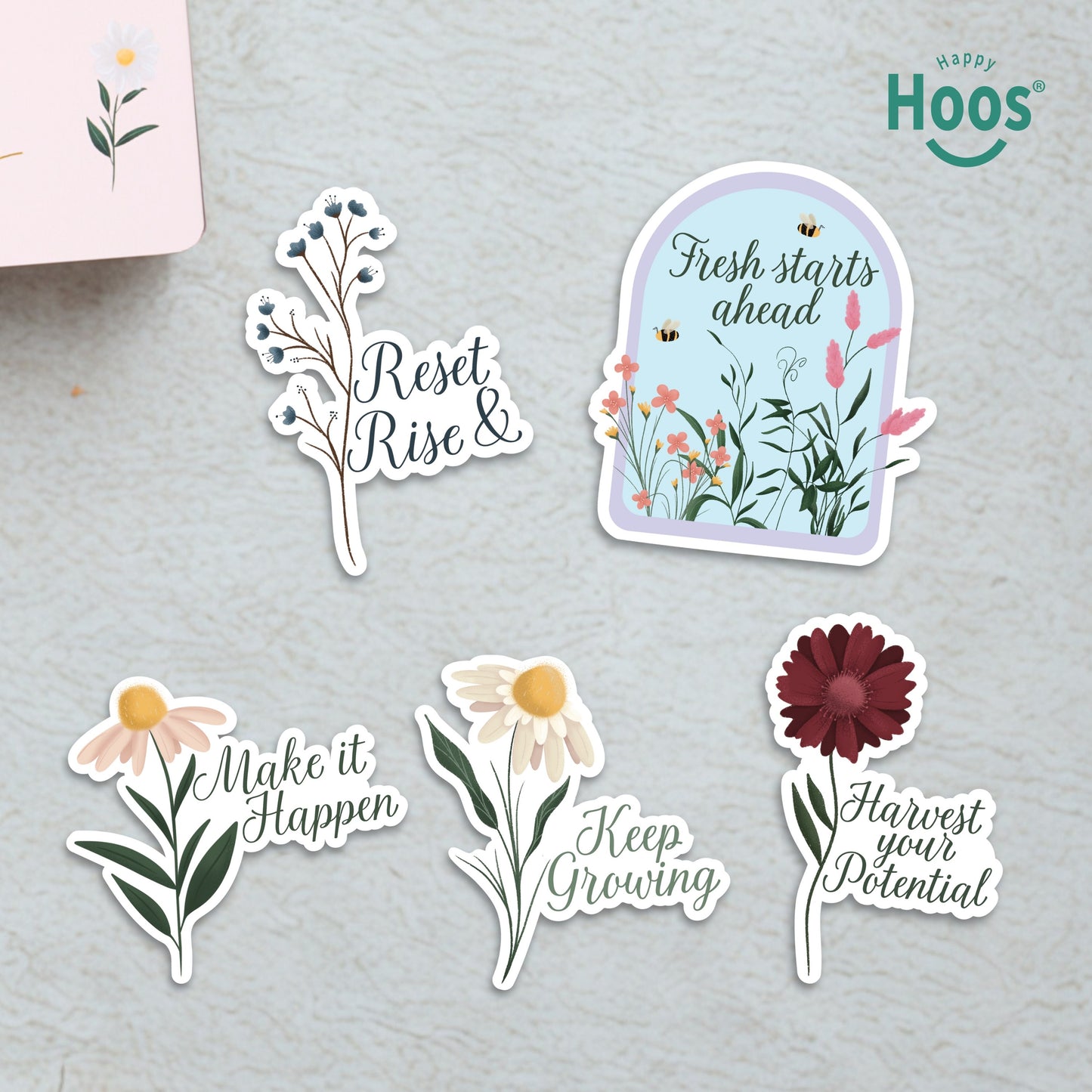 Five Growth & Goal stickers on surface: blue berry branches with "Reset & Rise", garden dome with "Fresh starts ahead", daisy with "Make it Happen", white daisy with "Keep Growing", burgundy flower with "Harvest your Potential"