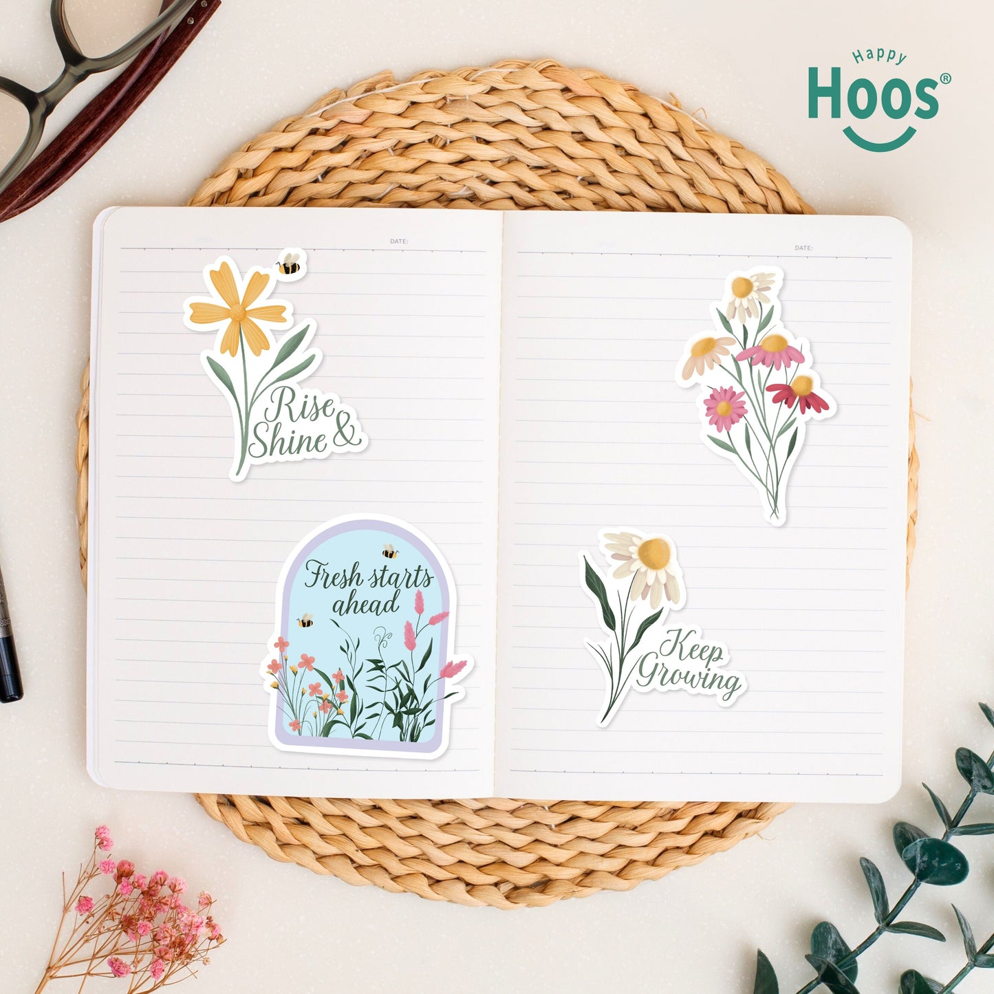 Spring stickers on open journal: daisy with bee and "Rise & Shine", garden dome with "Fresh starts ahead", colorful wildflower bouquet, daisy with "Keep Growing"