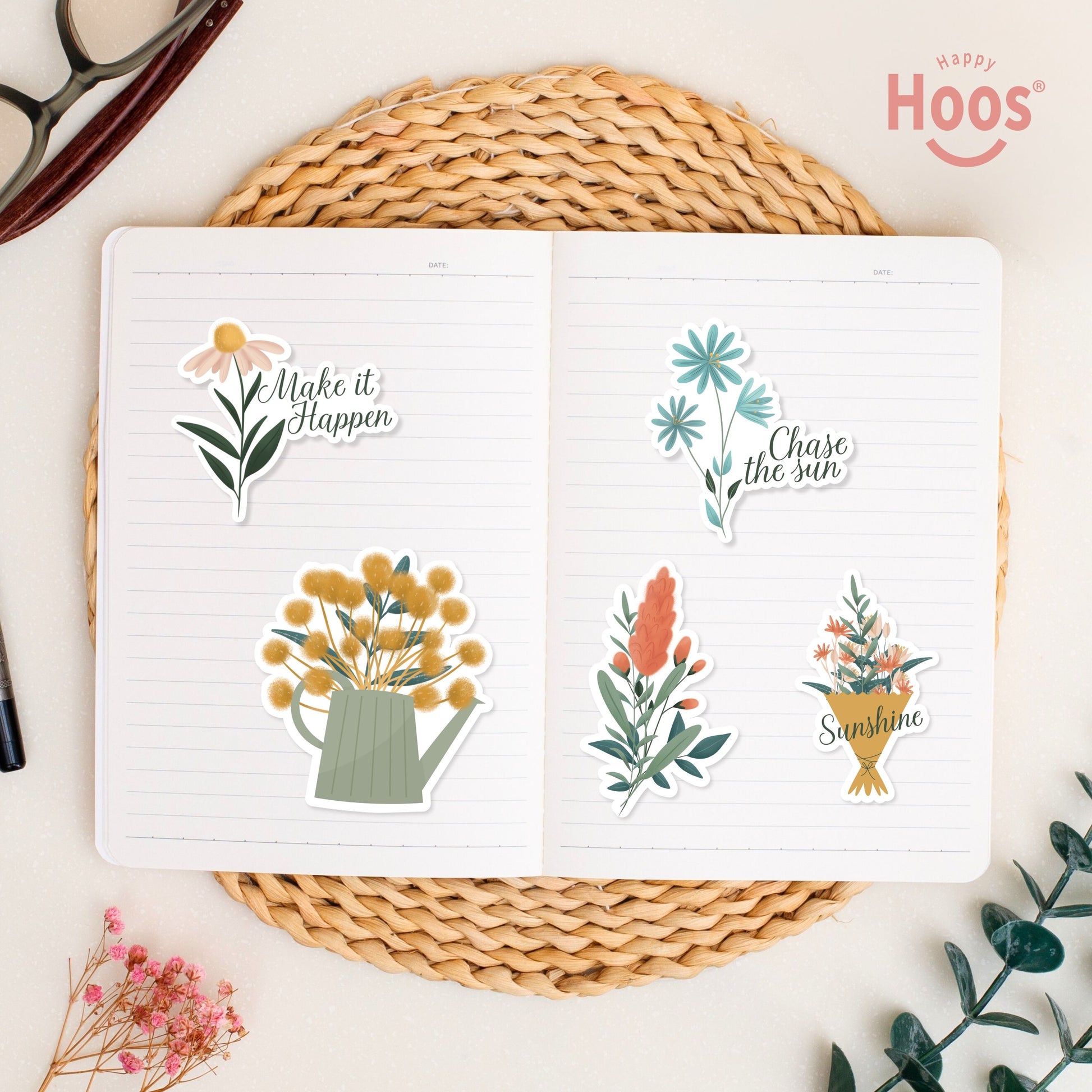 Summer stickers on open journal: daisy with "Make it Happen", yellow flowers in watering can, blue flowers with "Chase the sun", coral botanical stem, flower bouquet with "Sunshine"