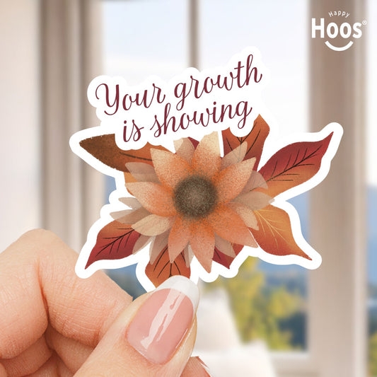 Sticker with sunflower design and 'Your growth is showing' text held by a hand, with 'Happy Hoos' logo.