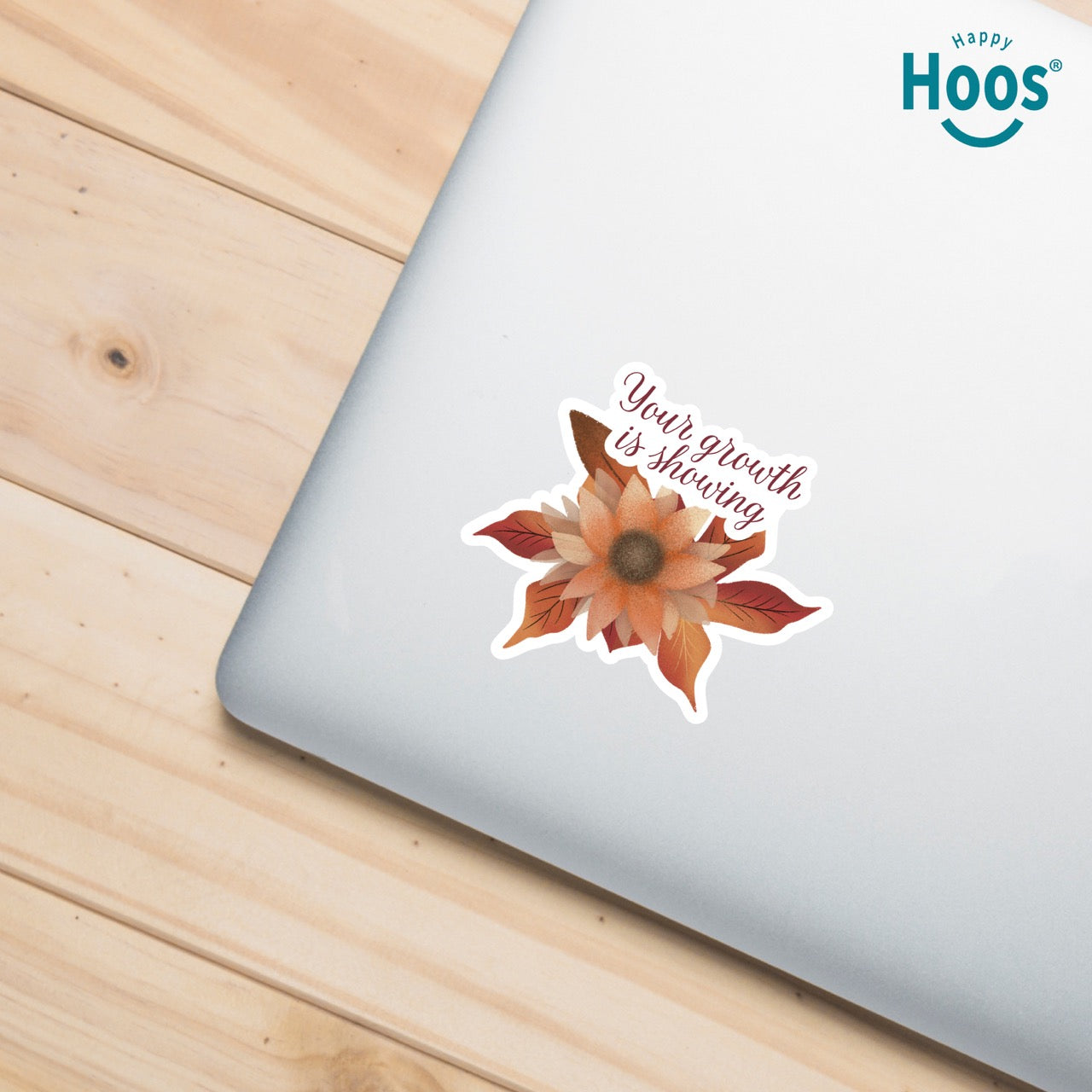 Autumn Growth sticker featuring a watercolor sunflower in autumn tones of orange, rust, and brown with fall leaves, and burgundy script lettering reading "Your growth is showing" at the top, measuring 3.3 by 2.9 inches on silver laptop