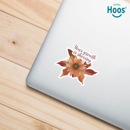 Autumn Growth sticker featuring a watercolor sunflower in autumn tones of orange, rust, and brown with fall leaves, and burgundy script lettering reading "Your growth is showing" at the top, measuring 3.3 by 2.9 inches on silver laptop
