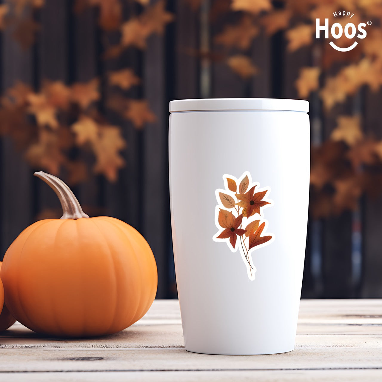 Autumn Florals sticker featuring burnt orange and rust-colored flowers with star-shaped petals and matching autumn leaves arranged in a vertical floral spray, measuring 2.5 by 3.8 inches on a white tumbler
