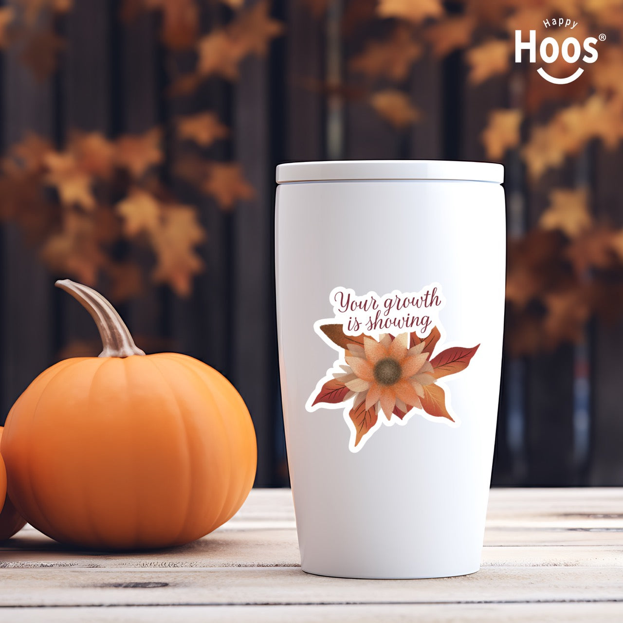 white tumbler with Autumn Growth sticker featuring a watercolor sunflower in autumn tones of orange, rust, and brown with fall leaves, and burgundy script lettering reading "Your growth is showing" at the top, measuring 3.3 by 2.9 inches