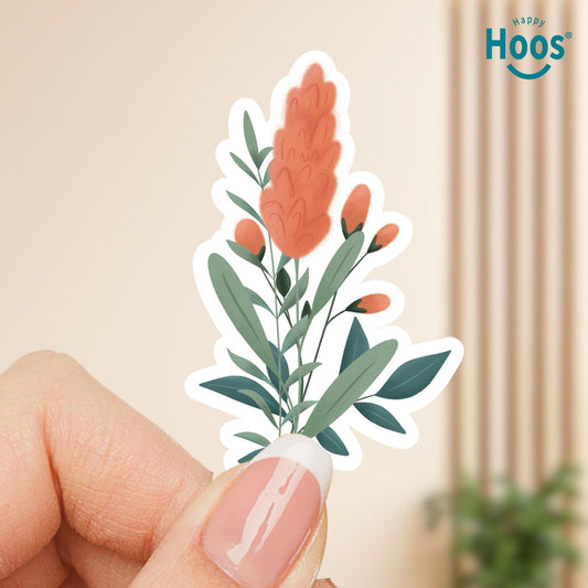 Hand holding a floral sticker with 'Happy Hoos' logo in the corner