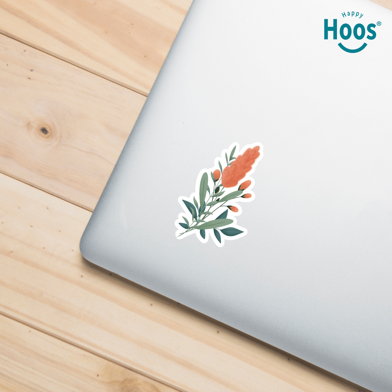 Floral sticker on a laptop with 'Happy Hoos' branding in the corner.