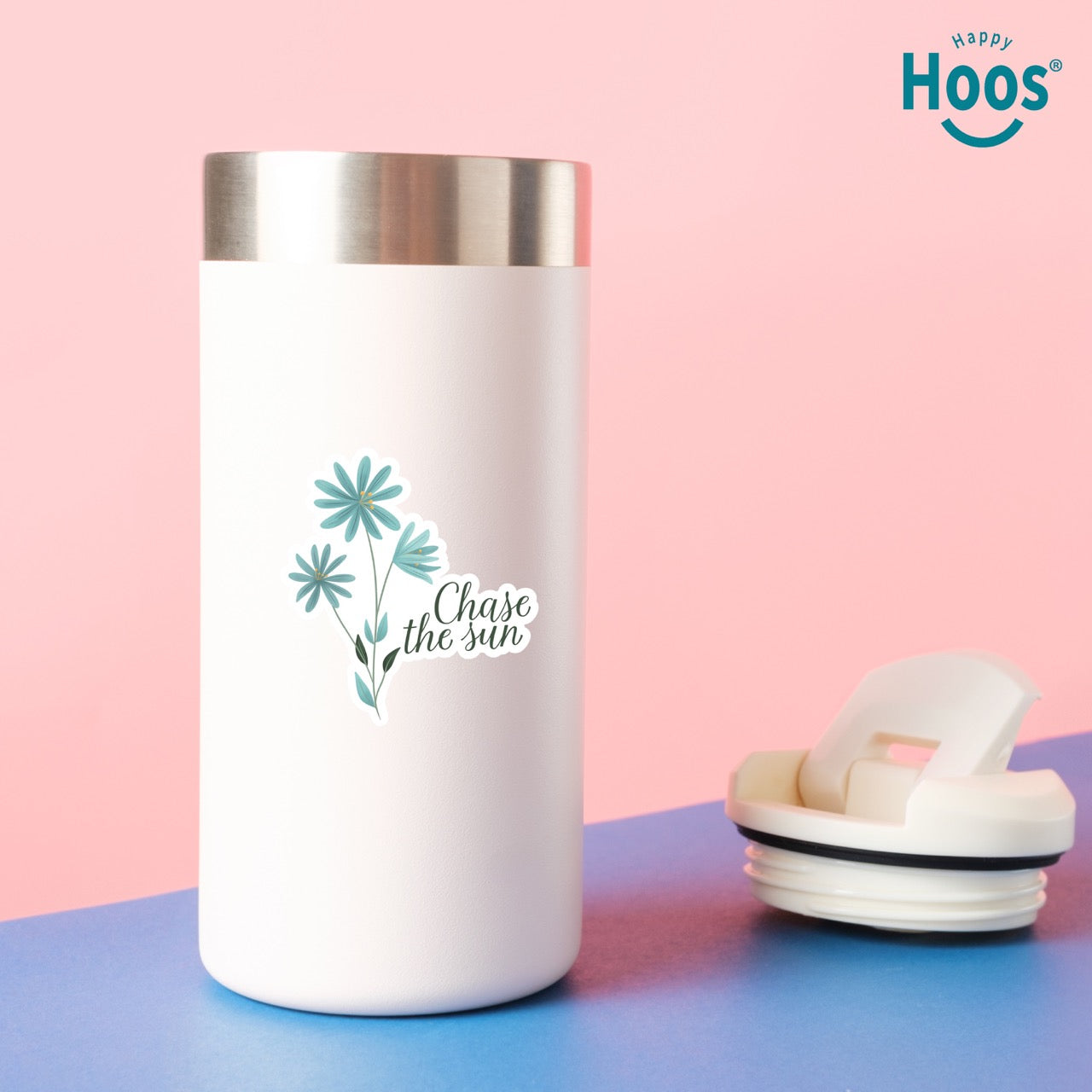 White tumbler with floral design and text on a pink and blue background, featuring the 'Happy Hoos' brand.