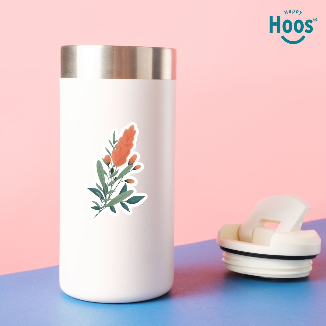 White tumbler with floral design on a pink and blue background, featuring the 'Happy Hoos' brand.