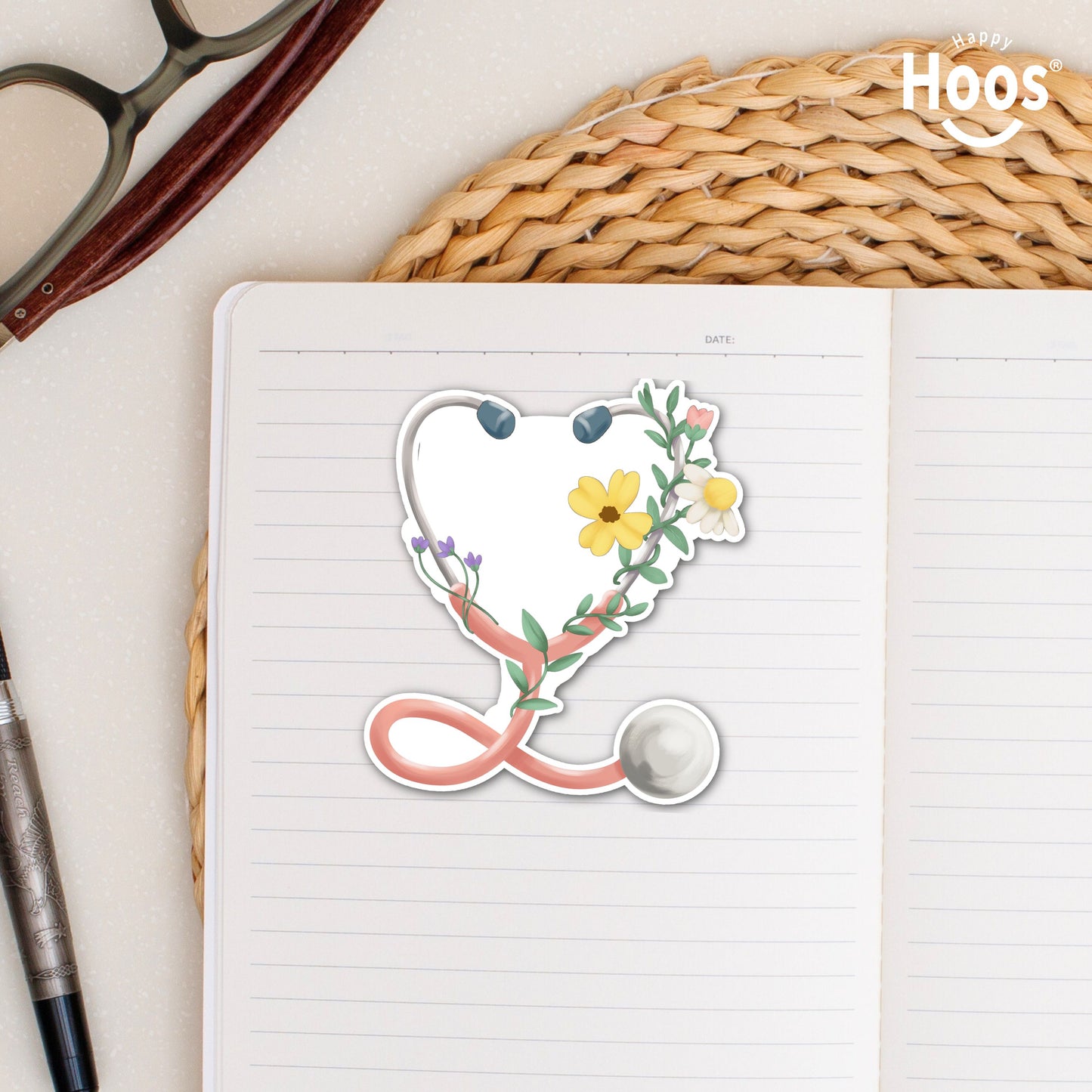 Floral Stethoscope waterproof sticker featuring a pink stethoscope wrapped with flowers and greenery for nurses and healthcare workers on notebook