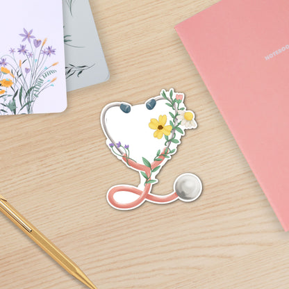 Floral Stethoscope waterproof sticker featuring a pink stethoscope wrapped with flowers and greenery for nurses and healthcare workers on wooden table
