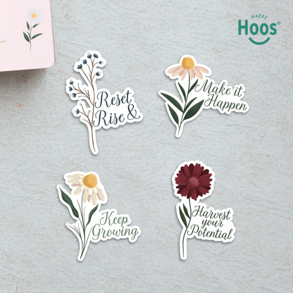 Four Goal Getter stickers on surface: blue berry branches with "Reset & Rise", daisy with "Make it Happen", white daisy with "Keep Growing", burgundy flower with "Harvest your Potential"