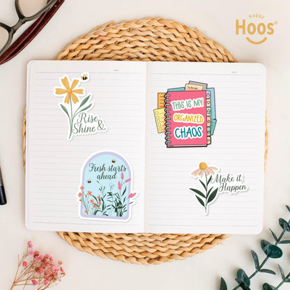Teacher stickers on open journal: yellow daisy with bee and "Rise & Shine", garden dome with "Fresh starts ahead", planner with tabs and "This is my Organized Chaos", daisy with "Make it Happen"