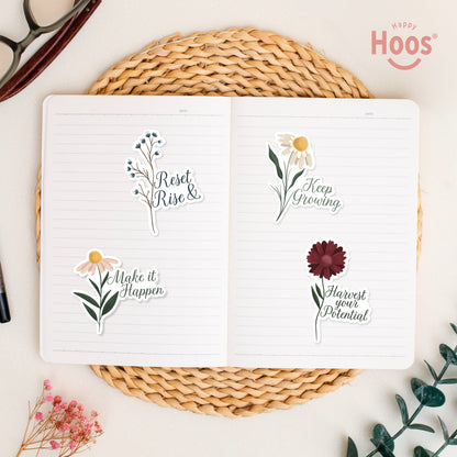 Goal Getter stickers on open journal: blue berry branches with "Reset & Rise", daisy with "Make it Happen", white daisy with "Keep Growing", burgundy flower with "Harvest your Potential"