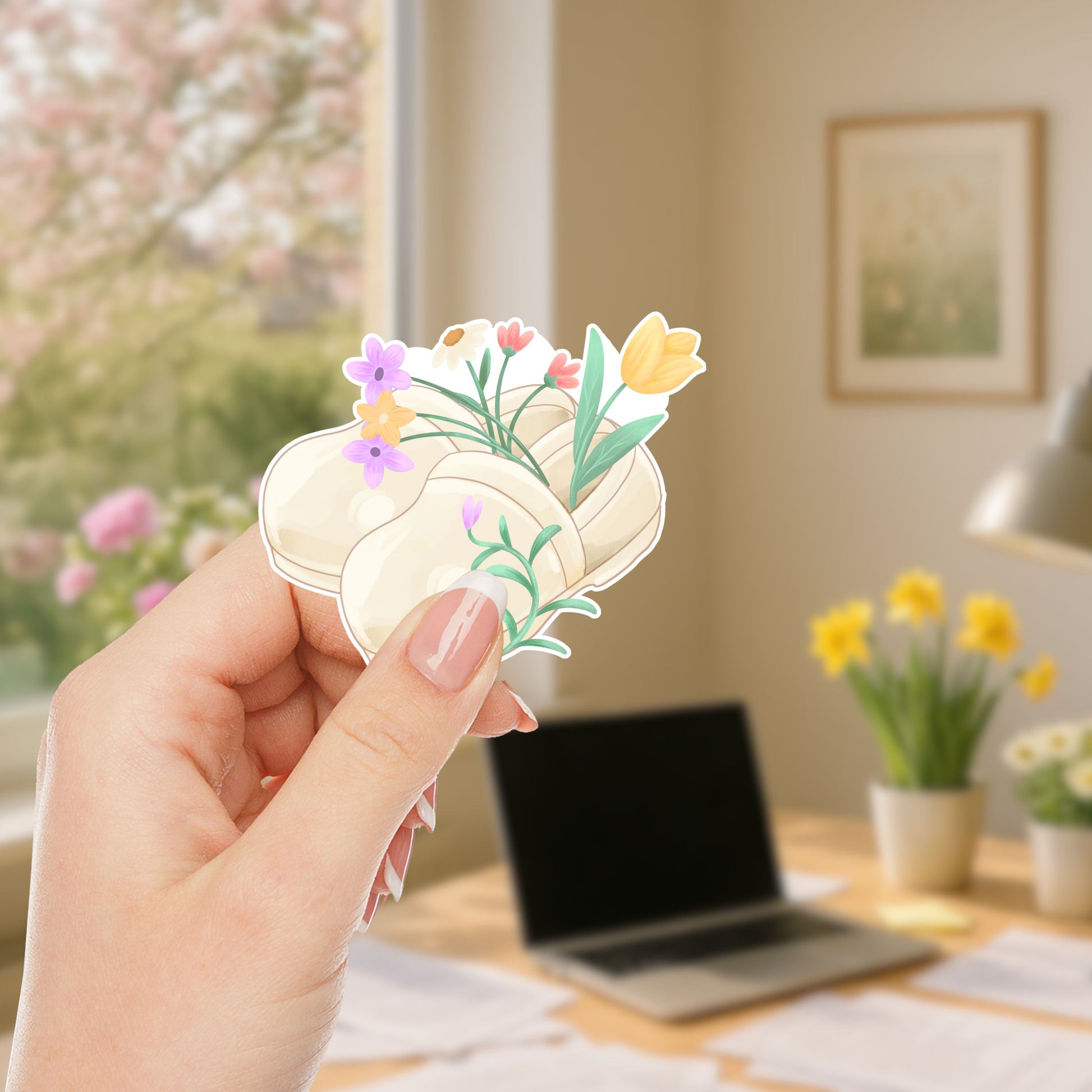 Woman holding Floral Nurse Clogs waterproof vinyl sticker featuring cream nursing shoes filled with colorful spring flowers for nurses and healthcare workers.