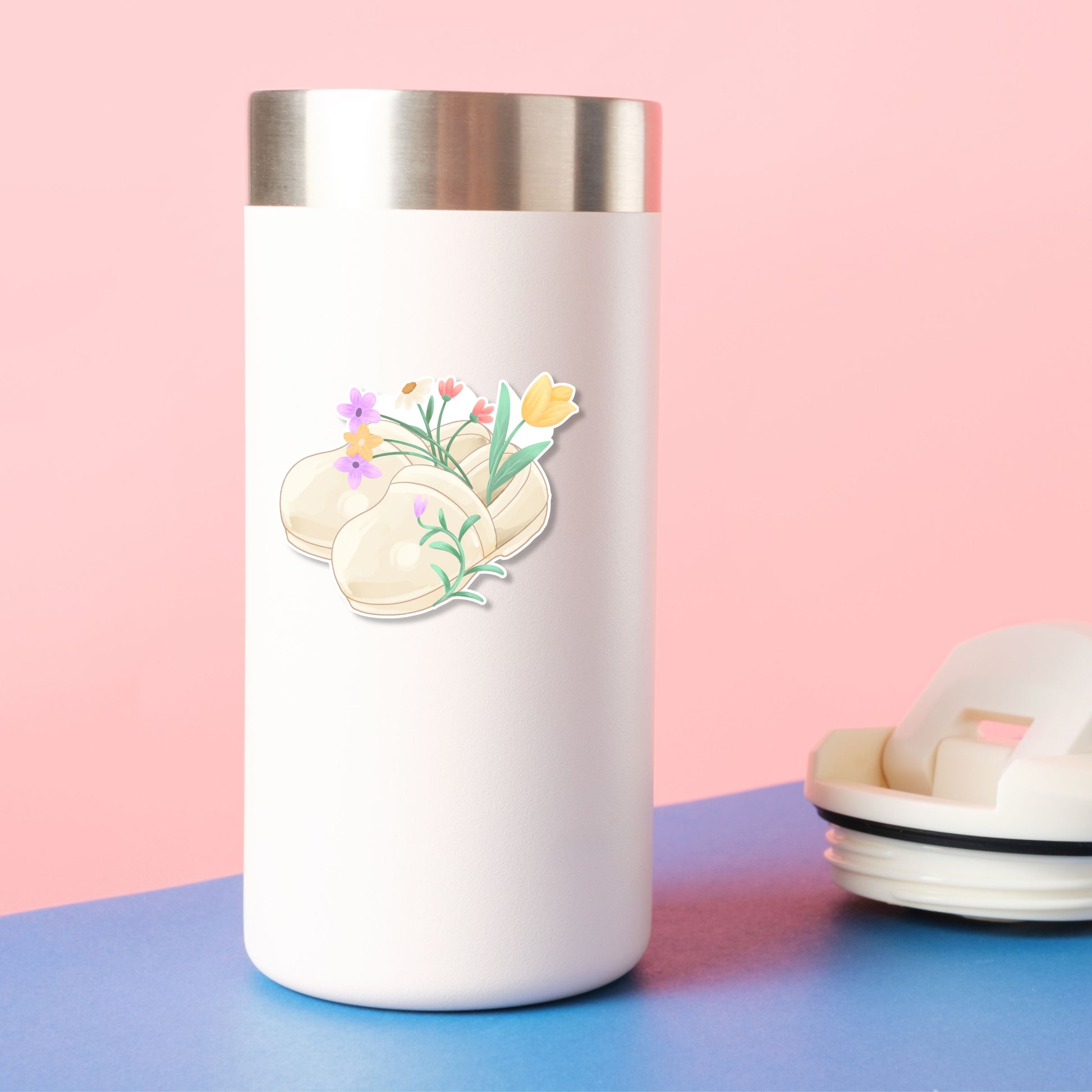 Floral Nurse Clogs waterproof vinyl sticker on a water bottle featuring cream nursing shoes filled with colorful spring flowers for nurses and healthcare workers.