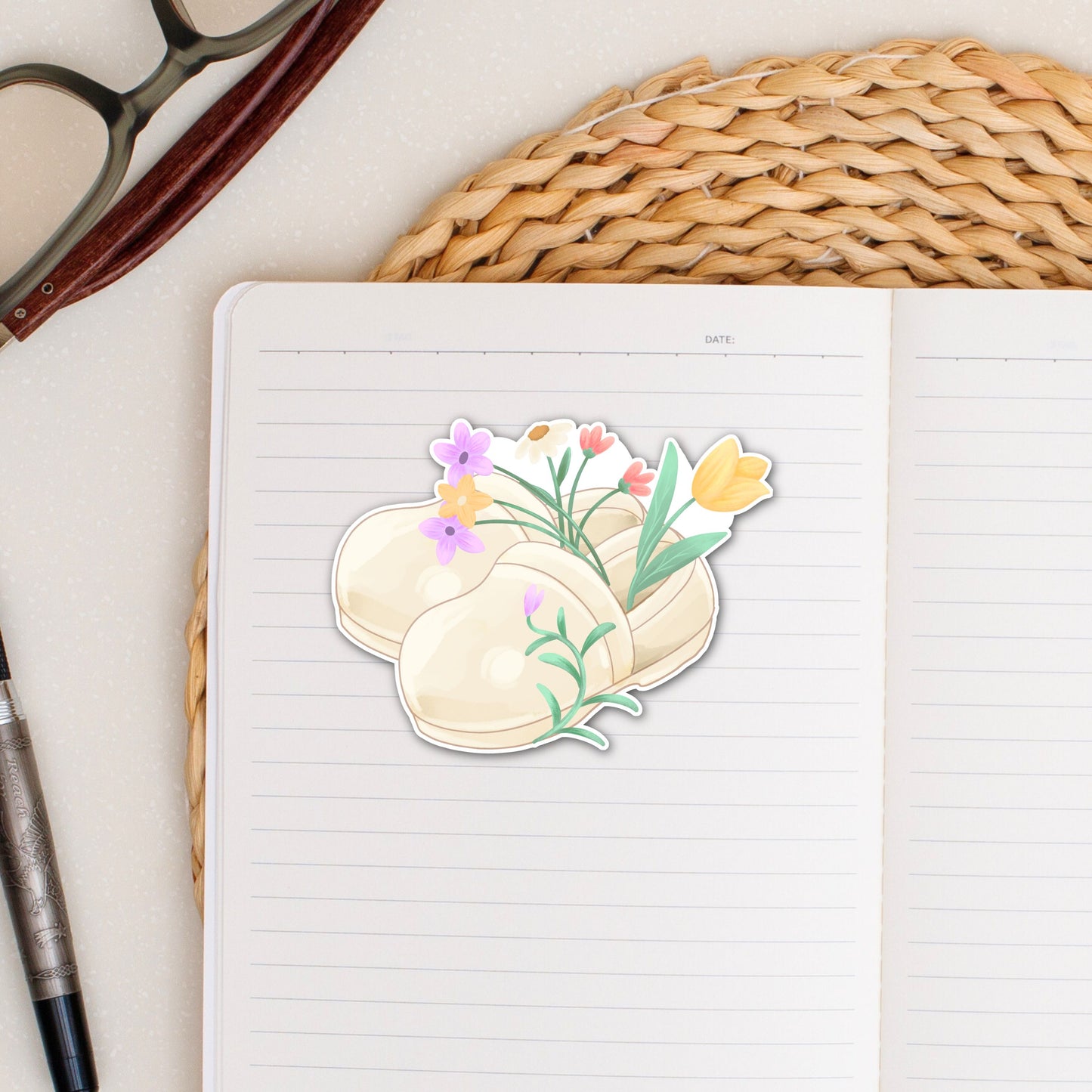 Floral Nurse Clogs waterproof vinyl sticker on a notebookfeaturing cream nursing shoes filled with colorful spring flowers for nurses and healthcare workers.