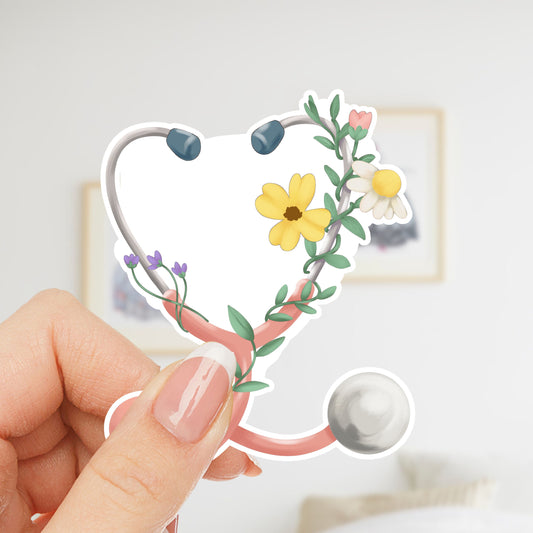 Woman holding Floral Stethoscope waterproof sticker featuring a pink stethoscope wrapped with flowers and greenery for nurses and healthcare workers.
